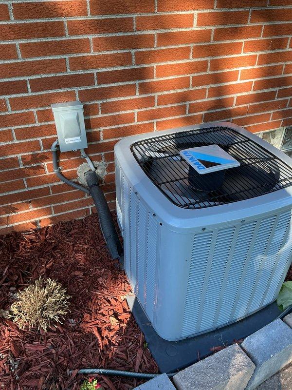 Completed comprehensive Gold AC Inspection on a 5-year-old residential air conditioning system with outdoor condenser unit and basement-located air handler. Performed full system evaluation including visual inspection of condenser unit mounted on exterior pad against brick wall, verified proper refrigerant line connections and electrical disconnect box functionality, and inspected indoor heating and cooling equipment. System found to be operational with no immediate service needs identified at time of inspection.