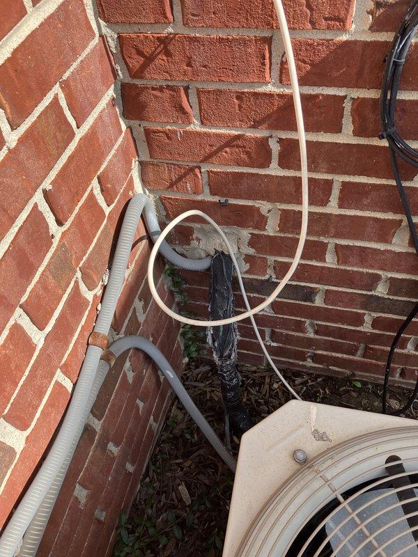 Conducted on-site evaluation of existing 20-year-old 2.5-ton air conditioning system located at front of property adjacent to porch. Assessed current condenser unit condition, noting age-related wear, rust formation on exterior housing, and deterioration of mounting components. Documented existing installation configuration including refrigerant line routing along brick exterior, electrical disconnect box placement, and conduit runs. Photographed equipment positioning, utility connections, and surrounding installation area to support replacement estimate preparation. Provided customer with replacement system options and discussed available financing programs for new equipment installation.