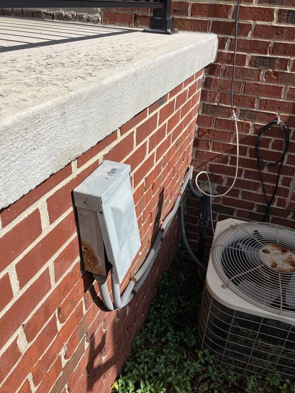 Conducted on-site evaluation of existing 20-year-old 2.5-ton air conditioning system located at front of property adjacent to porch. Assessed current condenser unit condition, noting age-related wear, rust formation on exterior housing, and deterioration of mounting components. Documented existing installation configuration including refrigerant line routing along brick exterior, electrical disconnect box placement, and conduit runs. Photographed equipment positioning, utility connections, and surrounding installation area to support replacement estimate preparation. Provided customer with replacement system options and discussed available financing programs for new equipment installation.