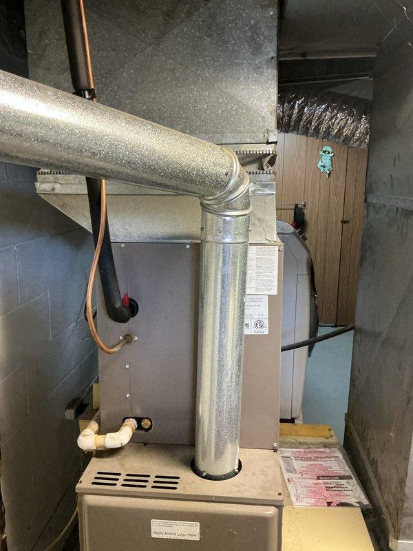 Responded to no airflow complaint with ice buildup on refrigerant lines. Diagnosed 10-year-old AC system with low refrigerant charge causing evaporator coil to freeze. Provided estimate for system replacement due to age and condition of existing equipment, including outdoor condensing unit and basement air handler installation.