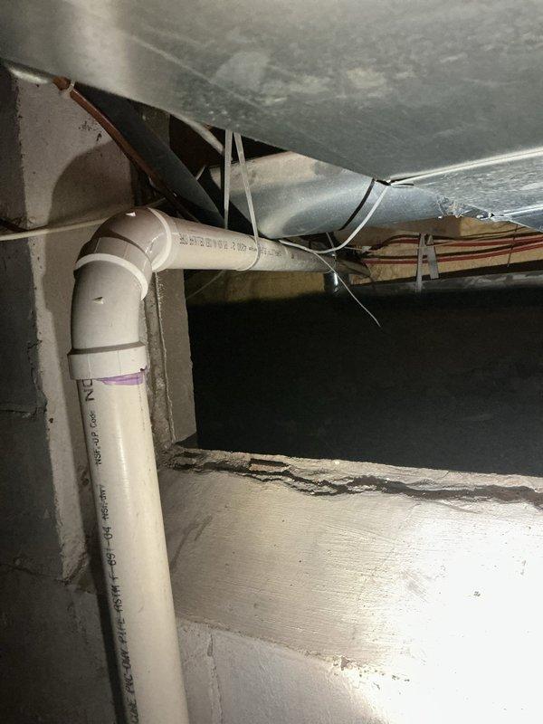 Responded to recurring kitchen sink drainage issue with persistent gurgling noises occurring over five-day period. Previous drain clearing attempts in April provided only temporary relief. Performed main line snaking procedure to clear obstruction and restore proper drainage flow. Inspected plumbing infrastructure in basement area, documenting existing PVC and older metal pipe connections at junction points to assess system condition and identify potential causes of recurring blockage.