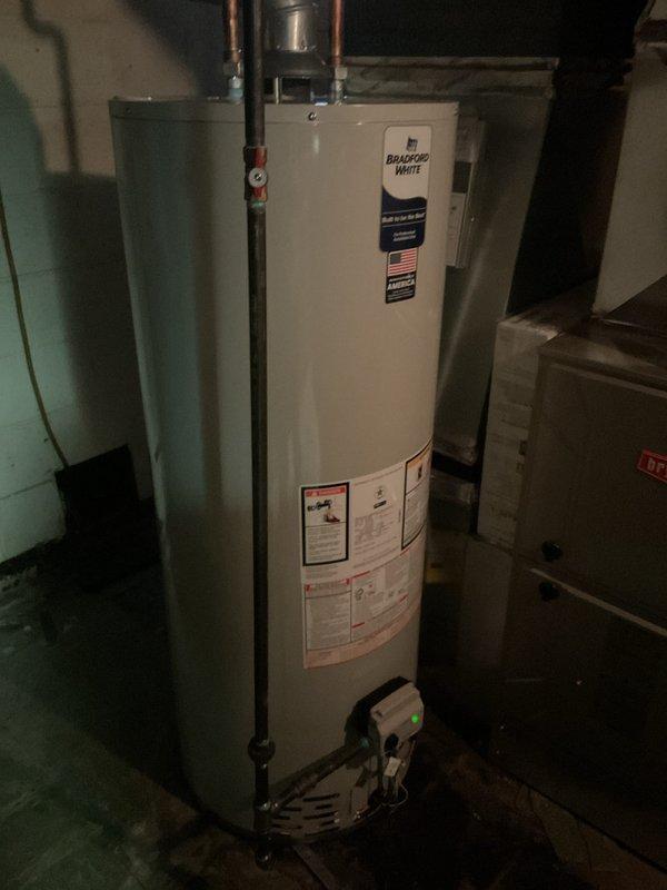 Responded to warranty callback for recently installed Bradford White tank water heater experiencing internal leak. Confirmed failure by removing burner door and inspecting unit, finding water leakage from tank itself requiring full warranty replacement. During inspection, also identified new leak at connection point on 3-inch PVC exhaust pipe at top of nearby HVAC unit. Leak appears to have resulted from physical contact during previous installation work, as no prior signs of moisture or deterioration were present on PVC connections. Documented both issues with photographic evidence showing water heater installation with copper supply lines and HVAC system with white PVC venting. Coordinated with office to schedule follow-up appointment for warranty tank replacement and repair of damaged PVC exhaust connection.