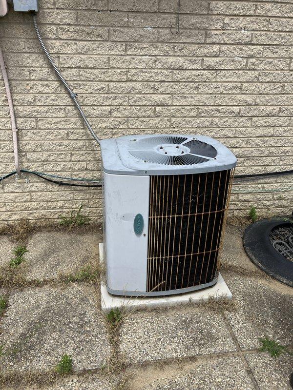Provided estimate for complete air conditioning system replacement of non-functional 30+ year old outdoor condenser unit. Assessed existing installation including electrical service, disconnect box, and condensate drainage requirements for new equipment sizing and placement on existing concrete pad. Documented current system configuration with natural gas furnace to ensure proper compatibility with replacement AC unit and verified electrical service capacity for new installation.