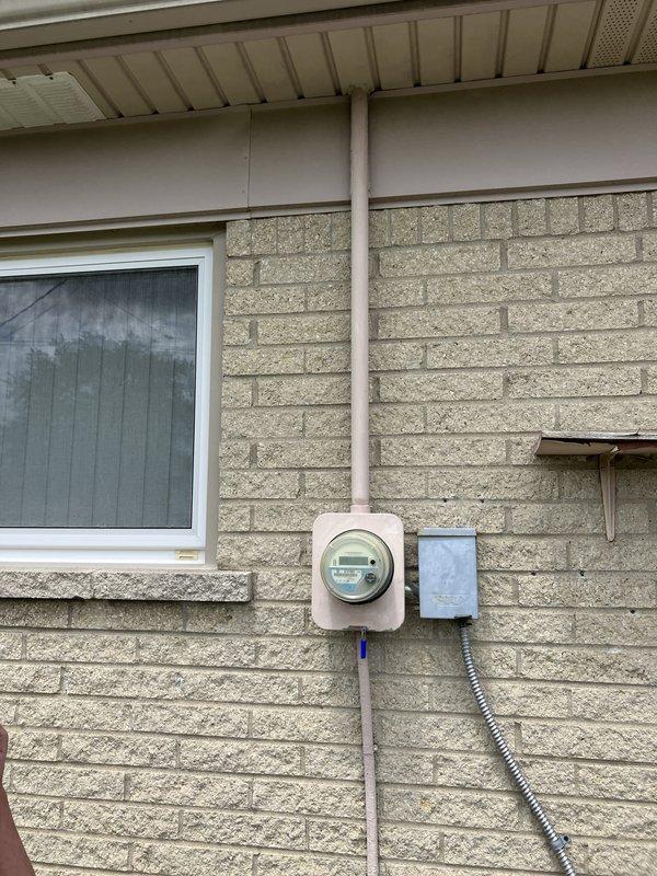 Provided estimate for complete air conditioning system replacement of non-functional 30+ year old outdoor condenser unit. Assessed existing installation including electrical service, disconnect box, and condensate drainage requirements for new equipment sizing and placement on existing concrete pad. Documented current system configuration with natural gas furnace to ensure proper compatibility with replacement AC unit and verified electrical service capacity for new installation.