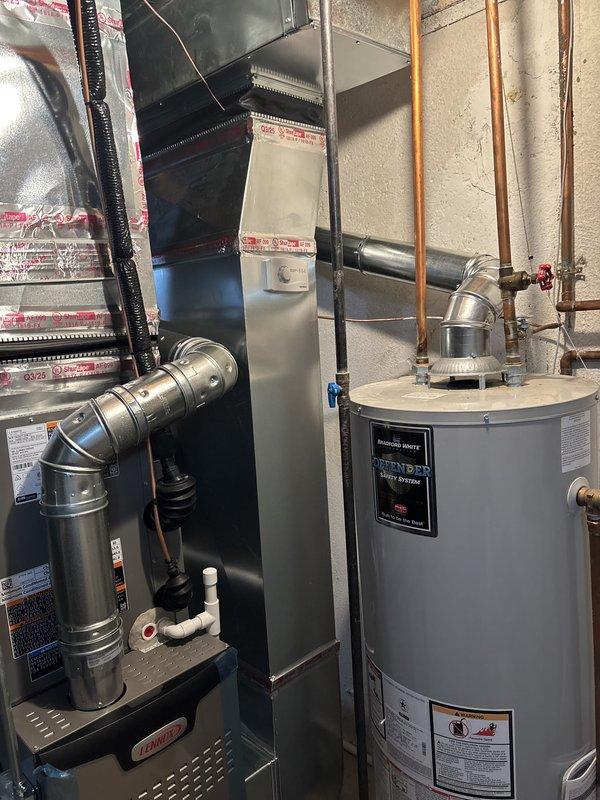 Completed full HVAC system installation including a 90,000 BTU furnace with left-side configuration and 2.5 ton air conditioning unit in residential utility space. Installed new thermostat and reconnected existing humidifier (AprilAire unit with digital control) to new system. All ductwork connections secured with proper sealing, mechanical and electrical permits obtained, and system tested for proper operation upon completion.