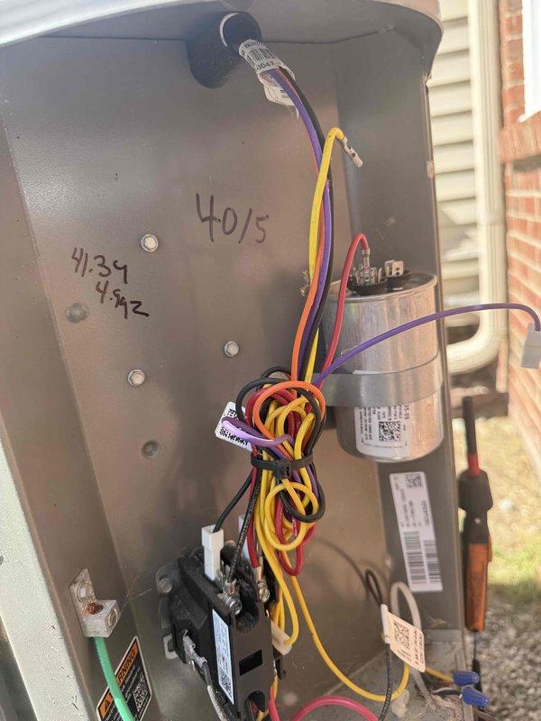 Completed comprehensive AC tune-up on 3-year-old outdoor condensing unit. Inspected and photographed electrical components including capacitor (40/5 MFD) and contactor, verified all wire connections secure, and assessed overall system operation. Interior air handler and ductwork in basement inspected and found in proper working condition.