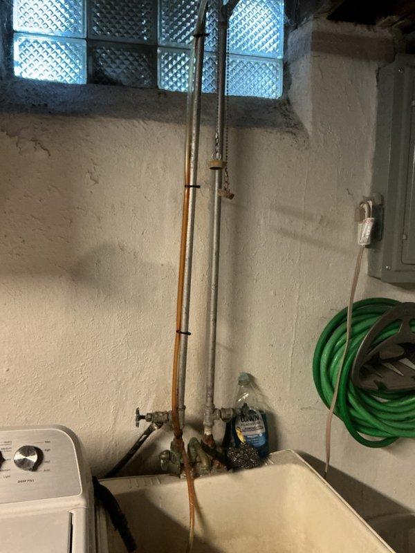 Responded to a shower leak in a first-floor bathroom of a 70-year-old home that had been active for approximately 30 days. Upon inspection, traced the source of the leak by accessing the basement utility area and examining the vertical supply lines and drainage system beneath the affected bathroom. Identified compromised piping connections in the aging plumbing infrastructure running through the basement ceiling joists, which was allowing water to seep through when the shower was in use. Shut off the water supply at the basement shutoff valve, assessed the condition of the copper and galvanized steel pipes, and made necessary repairs to eliminate the leak. Documented the existing plumbing configuration and condition with photographs for future reference.