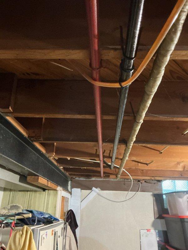 Responded to a shower leak in a first-floor bathroom of a 70-year-old home that had been active for approximately 30 days. Upon inspection, traced the source of the leak by accessing the basement utility area and examining the vertical supply lines and drainage system beneath the affected bathroom. Identified compromised piping connections in the aging plumbing infrastructure running through the basement ceiling joists, which was allowing water to seep through when the shower was in use. Shut off the water supply at the basement shutoff valve, assessed the condition of the copper and galvanized steel pipes, and made necessary repairs to eliminate the leak. Documented the existing plumbing configuration and condition with photographs for future reference.