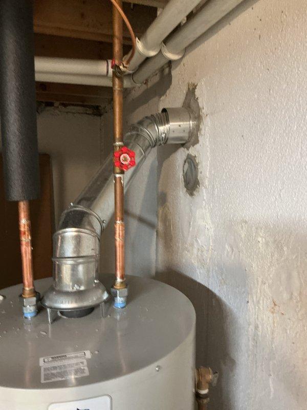 Installed 50-gallon tanked water heater with required drip pan to meet city code compliance. Connected hot and cold water supply lines using copper piping with shutoff valve, established proper plumbing configuration with push-fit connectors and fittings, and completed electrical reconnection to restore full operation of the unit.