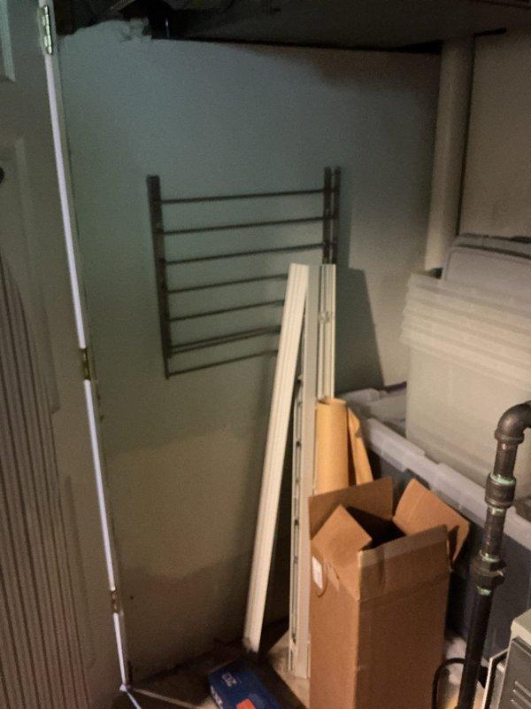Conducted inspection of water heater installation in utility room and identified code violation regarding inadequate combustion air supply. The water heater room requires proper ventilation with two combustion air openings—one positioned high near the ceiling and one low near the floor—sized at 1 square inch per 1,000 BTU input of installed appliances, with a minimum of 100 square inches per opening. Documented existing conditions with photographs showing the confined utility space housing the water heater and related mechanical equipment, noting the absence of code-compliant combustion air openings necessary for safe appliance operation.