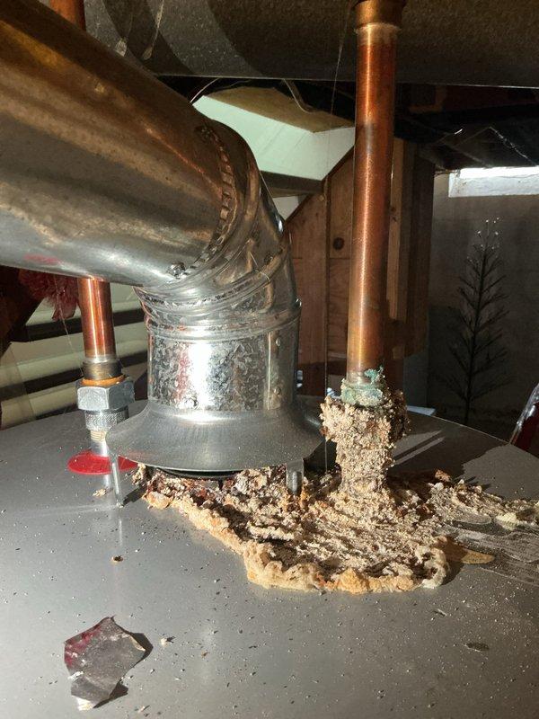 Completed comprehensive Gold AC tune-up and inspection on six-year-old residential air conditioning system located at rear of property. Performed standard maintenance protocol including examination of outdoor condenser unit, refrigerant lines, and indoor air handler components. During attic inspection, discovered significant accumulation of wood debris and sawdust near HVAC ductwork and copper refrigerant lines, likely indicating pest activity or recent construction work in the space. Documented conditions with photographs showing debris on platform near cylindrical metal ductwork and copper pipe connections. Verified outdoor condenser unit operational status, confirmed proper mounting on pad with adequate clearance, inspected refrigerant line routing across landscaped area, and noted all manufacturer labels intact. System currently functioning within normal parameters with no immediate mechanical concerns identified, though recommend addressing attic debris accumulation to prevent pot