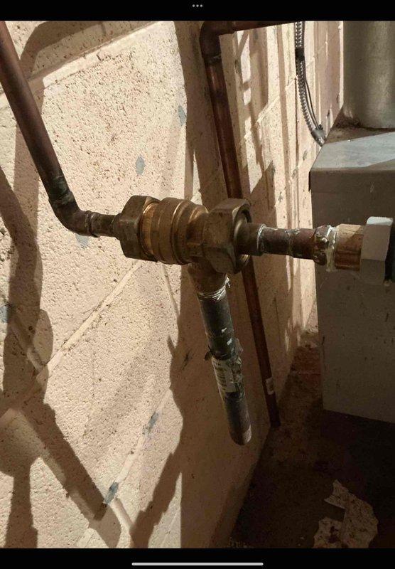 Responded to service call for 22-year-old boiler system located in basement with reported expansion tank concerns. Conducted thorough inspection of hydronic heating system components, including expansion tank, pressure relief valve, and associated copper piping connections. Evaluated brass valve assembly and galvanized steel piping for proper operation and signs of water hammer or pressure irregularities. Inspected copper pipe connections for oxidation, corrosion, and potential leak points at threaded fittings and junction points. Assessed expansion tank for waterlogging, proper air charge, and mounting integrity. Performed comprehensive boiler maintenance including system pressure verification, visual inspection of all plumbing connections, and evaluation of flexible connector hoses for deterioration. Documented condition of all visible components with photographic evidence showing valve configurations, pipe routing, and connection points for future reference and maintenance tracking.