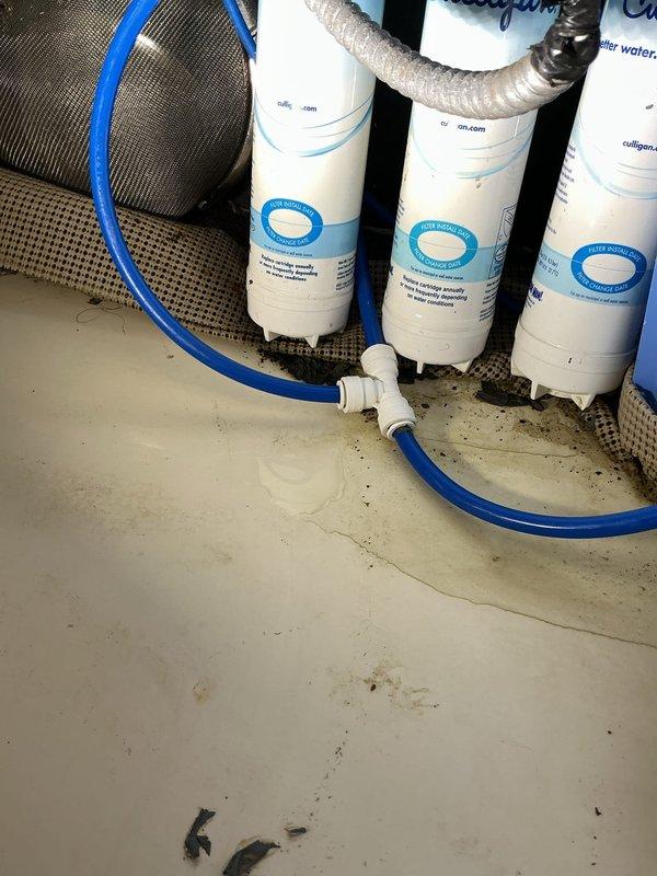 Responded to a sink leak complaint at a commercial medical office. Upon inspection, identified leak originating from deteriorated P-trap connections beneath the sink. Inspected the existing three-stage water filtration system with cylindrical cartridges and verified all filter housings and connections for potential leak sources. Examined PVC drain assembly, P-trap, and associated flexible supply lines. Tightened loose threaded connections on the P-trap assembly and replaced worn compression fittings. Cleaned debris from cabinet base and tested all plumbing connections under pressure to confirm leak resolution. System restored to proper working order with no active leaks detected upon completion.