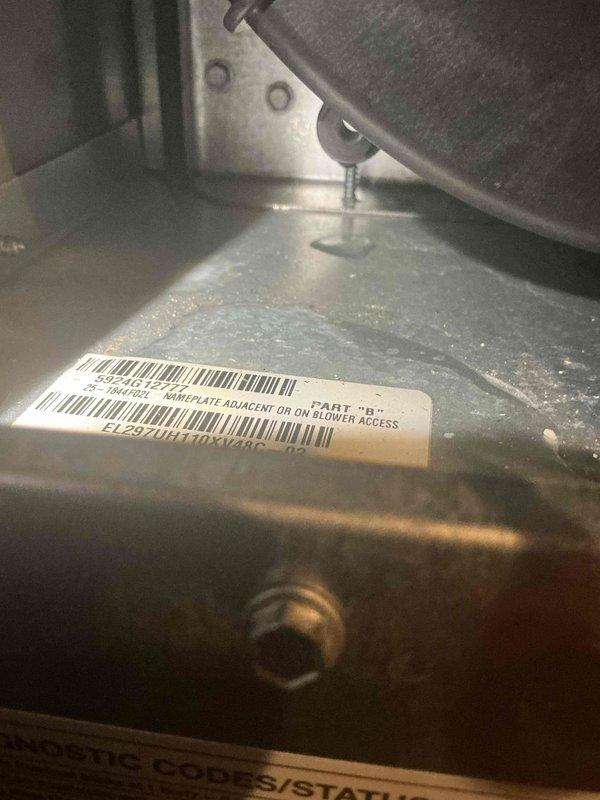 Responded to service call for 2-year-old furnace in basement with reported cracked drain pan. Upon inspection, confirmed visible crack in condensate drain pan with evidence of moisture accumulation on unit surfaces. System currently operational and providing heat. Documented existing condition with photos showing water droplets on exterior panels and unit nameplate information. Advised that evaporator coil replacement part is available at Lennox Madison Heights under existing purchase order for future repair coordination.