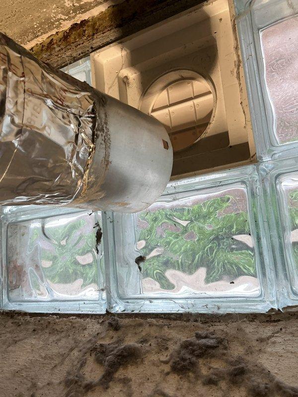 Responded to service call for disconnected dryer vent system. Upon inspection, found flexible duct hose detached from ceiling-mounted exhaust vent cover in bathroom/utility area. Replaced deteriorated tubing with new rigid or semi-rigid vent ducting and securely connected to exterior vent cover, ensuring proper seal and airflow. Verified ventilation system operates correctly with no air leaks at connection points.