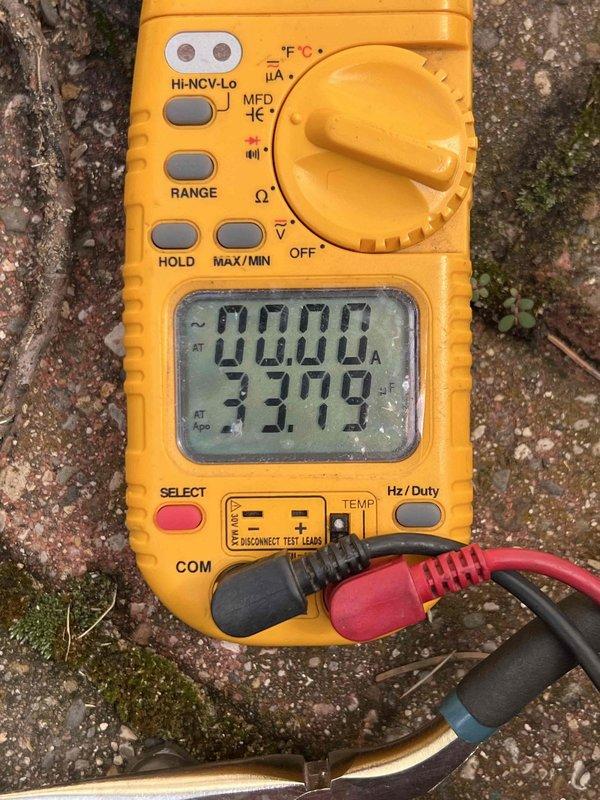 Performed comprehensive AC tune-up and inspection on 15-year-old residential air conditioning unit located in basement. Conducted refrigerant system diagnostics using digital multimeter and pressure testing equipment at outdoor condensing unit, checking service ports and electrical components. System evaluated for proper operation with capacitance readings taken and all mechanical components assessed for wear and functionality.