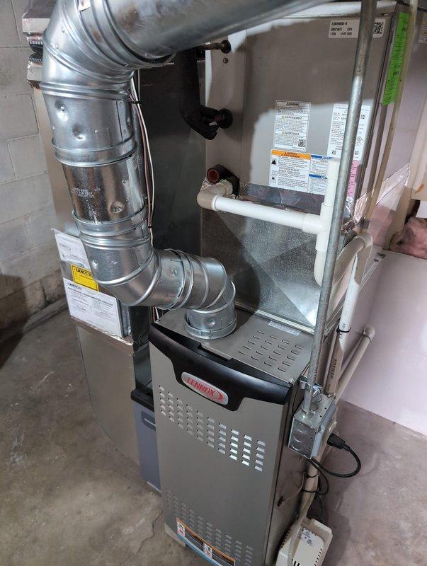 Completed HVAC installation warranty work to address City of Warren code violations. Corrected B-vent installation to ensure proper 1-inch clearance from combustible PVC materials and A/C drain line per code requirements. Installed mortar collar and B-vent to liner adapter according to manufacturer specifications outlined in page 9 of liner assembly instructions. Leveled evaporator coil to ensure proper condensate drainage and adjusted furnace positioning to maintain correct canvas clearance specifications. Corrected water heater pitch for proper operation and code compliance. Protected low voltage wiring entering unit from potential damage by condensate pump. All corrections made to bring installation into compliance with local building codes and manufacturer installation guidelines.