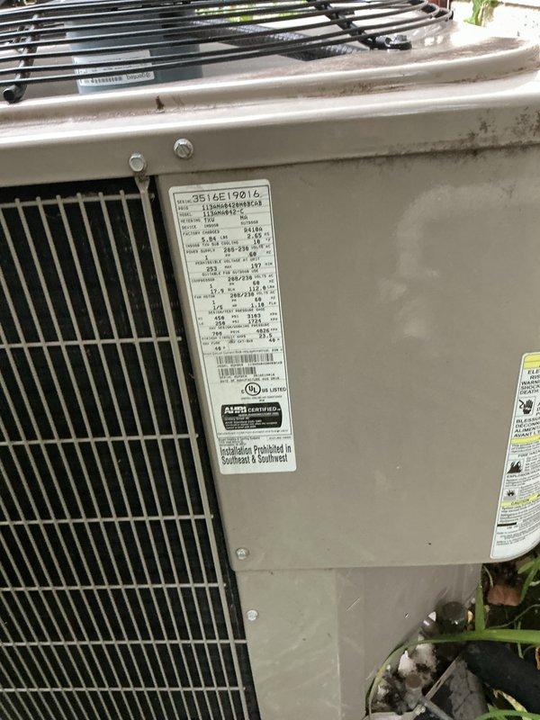 # HVAC Maintenance - Gold AC Inspection

Performed comprehensive Gold-level preventive maintenance inspection on outdoor air conditioning condenser unit located in backyard. Unit age was unknown at time of service, identified as model 3516E19016 based on manufacturer specification label.

## Work Performed

Conducted thorough visual inspection of condenser unit exterior, noting beige metal cabinet construction with protective grille cage covering condenser coils. Inspected vertical black metal protective barrier and confirmed proper securing of all fastening hardware. Examined black horizontal refrigerant lines and heat exchanger components at top of unit for signs of damage or leaks.

Verified electrical disconnect box mounted on exterior wall, confirming proper operation of ON/OFF switch mechanism and secure mounting. Inspected white PVC electrical conduit routing from disconnect to unit. Checked all electrical connections for tightness and proper clearances per manufacturer specific