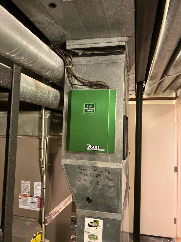 Completed site assessment and documentation for HVAC system quotation. Inspected and photographed existing three-zone forced air system including main air handler unit with Green Zone Z30 control panel serving main floor, second floor, and basement zones. Documented all visible ductwork, copper piping, water heater connections, and mechanical infrastructure to prepare accurate estimate for requested work.