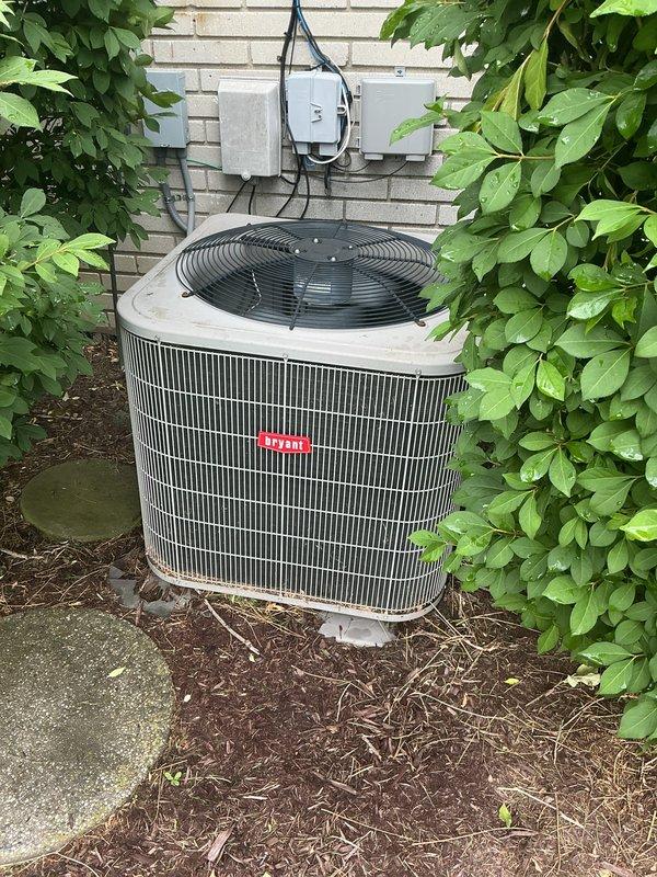 Completed comprehensive Gold AC Inspection on residential cooling system with basement-located air handler and outdoor condenser unit. Performed thorough multi-point inspection including visual examination of outdoor condenser unit positioned on concrete pad, verified proper clearances and surrounding vegetation, inspected electrical disconnect box and conduit connections, and assessed indoor air handler components. System found to be operational with all equipment functioning within normal parameters at time of inspection.