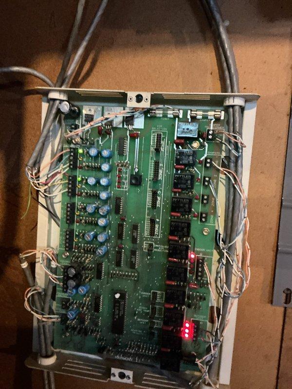 Responded to no cooling call on 3-year-old system with zone control. Previous technician had bypassed circuit board protection with jumper wire, and required fuse was never provided to homeowner. Inspected zone control board in basement and documented current wiring configuration showing multiple zone relays and damper controls. System inoperable due to improper previous repair and missing overcurrent protection device.