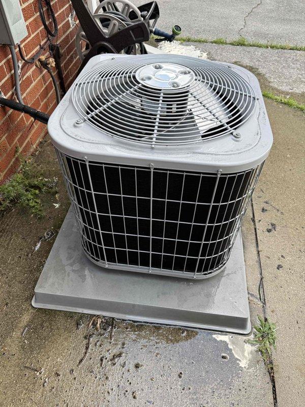 Completed annual Gold Member AC tune-up and inspection on 13-year-old Carrier cooling system. Performed comprehensive maintenance including condenser unit examination, electrical disconnect verification, refrigerant line inspection, and airflow assessment. System confirmed operating properly with all components functioning within normal parameters; outdoor unit properly positioned on concrete pad with adequate clearance and ventilation through mesh grilles and fan assembly.