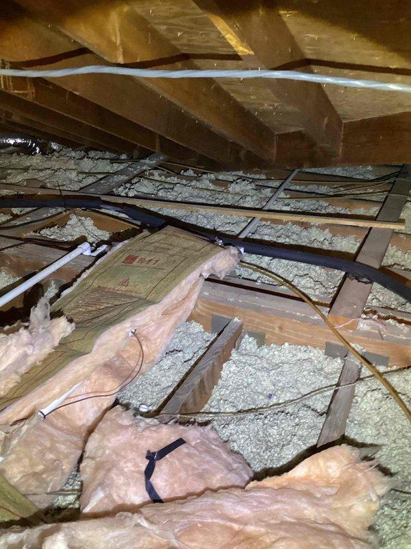 Conducted comprehensive inspection and estimate for replacement of 23-year-old SpacePak high-velocity HVAC system located in attic space. Assessed existing ductwork, insulation conditions, and structural accessibility for new equipment installation, documenting displaced insulation and current system configuration with flexible duct runs and PVC condensate drainage.