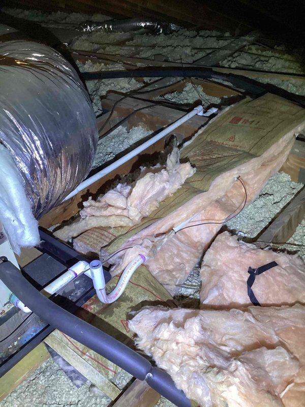 Conducted comprehensive inspection and estimate for replacement of 23-year-old SpacePak high-velocity HVAC system located in attic space. Assessed existing ductwork, insulation conditions, and structural accessibility for new equipment installation, documenting displaced insulation and current system configuration with flexible duct runs and PVC condensate drainage.
