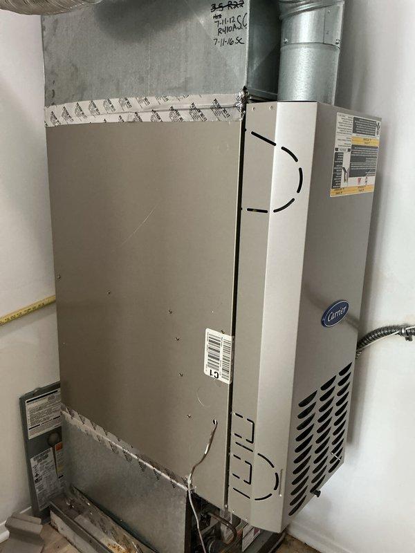 Completed comprehensive tune-up and city certification inspection on 10+ year old furnace and air conditioning system located in basement. Performed full system evaluation including inspection of Carrier heating unit, air handler, and associated ductwork. Verified proper operation of gas supply manifold with multiple branch lines, confirmed functionality of shut-off valves and pressure regulation equipment. Inspected all electrical connections, tested safety controls, and verified proper airflow through ductwork and ventilation systems. Noted existing corrosion on gas line floor flange and base connections, though components remain functional. Cleaned and inspected blower assembly, checked refrigerant levels, tested thermostat operation, and verified proper cycling of both heating and cooling modes. All duct connections properly sealed with foil tape, no air leakage detected. System operating within manufacturer specifications and meets requirements for municipal certification. Equipme