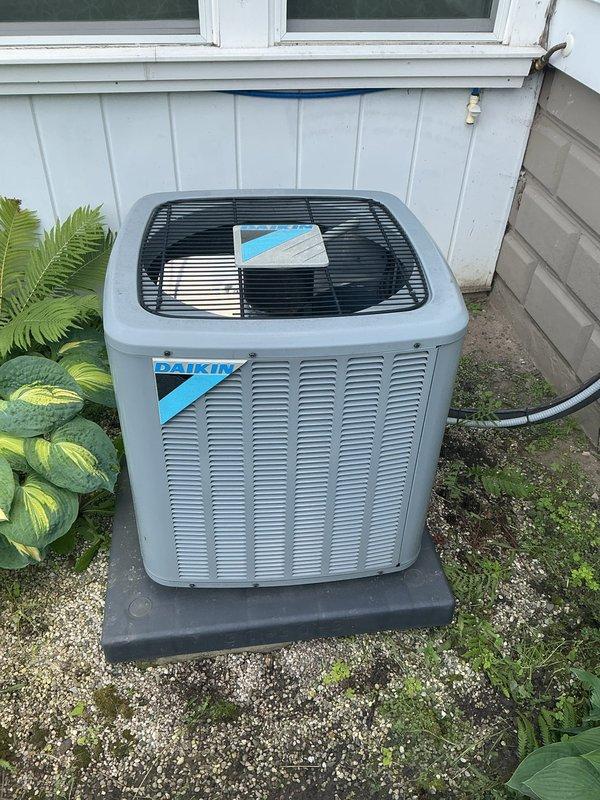 Completed comprehensive Gold AC Inspection on a 7-year-old Daikin outdoor condensing unit and basement air handler system. Performed full system evaluation including visual inspection of outdoor unit showing good overall condition with no visible damage, proper mounting on rubber isolation pad, and secure refrigerant line connections. Inspected indoor air handler located in basement utility area, verified proper installation and secure ductwork connections. System currently operating as designed with no immediate service needs identified. Customer requested filter replacement service, which was addressed during the inspection visit.