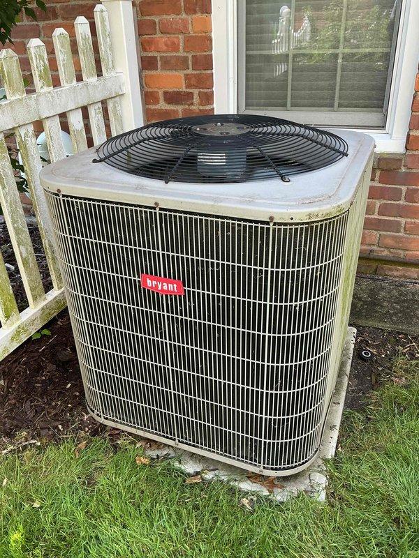 Completed comprehensive Gold AC inspection on Bryant 113ANA048 condenser unit, serial number 4909E10744, utilizing R410A refrigerant with factory charge of 7.08 lbs. Performed full system evaluation including visual inspection of outdoor condenser unit positioned on concrete pad against brick exterior, confirmed proper mounting and clearances. Inspected manufacturer specifications, verified electrical ratings at 208-230 volts AC, 60 Hz, and documented compressor specifications. Evaluated exterior cabinet condition noting age-related weathering consistent with equipment over 10 years old. Assessed indoor air handler located in basement. Documented unit condition through photographic records showing operational equipment with typical wear patterns. System operational at time of inspection with all components accessible and functioning within manufacturer specifications.