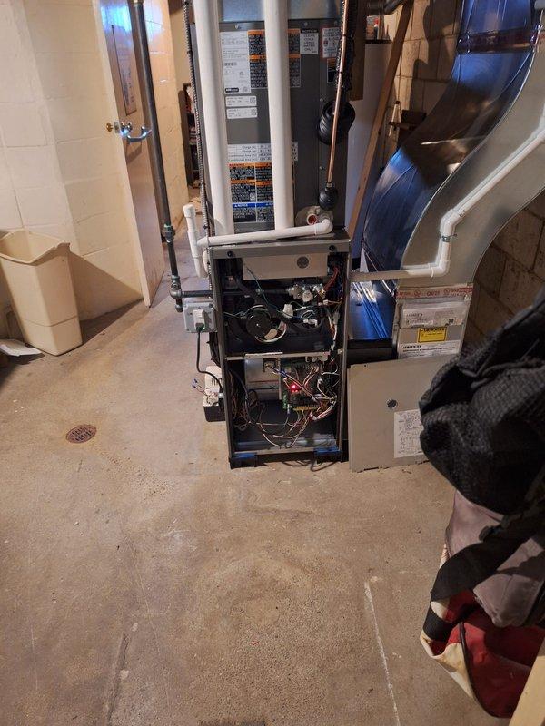 Completed full HVAC system installation including a 70,000 BTU furnace, 2-ton rear-discharge air conditioning unit, programmable thermostat, and humidifier in basement utility area. Installed all ductwork connections, reconnected existing electrical service, and integrated condensate pump with drainage system. Mechanical, electrical, and furnace permits secured for compliance; system registered under AHRI certificate 215584890 and qualified for utility energy efficiency rebates.