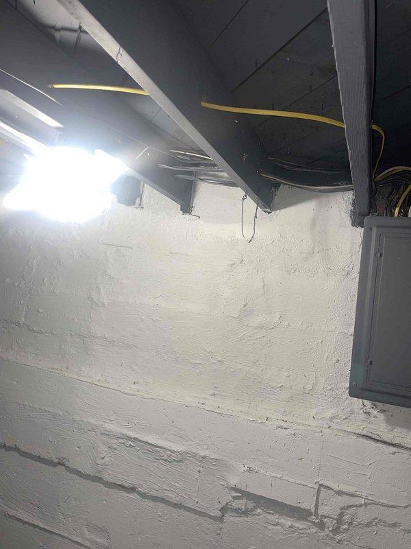 Completed estimate for new air conditioning system installation at residence with no existing AC unit. Customer requested outdoor condenser placement on rear side of property. Assessed basement utility area with existing ductwork infrastructure, evaluated electrical panel location and capacity for new system integration. Photographed installation site including current HVAC ductwork configuration, structural supports, and available space for equipment placement. Provided comprehensive estimate for complete AC system installation including outdoor condenser unit, indoor air handler or evaporator coil integration with existing ductwork, refrigerant line set, electrical connections, condensate drainage, and thermostat wiring.