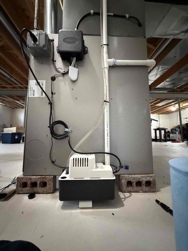 Responded to water leak call for 1-year-old AC system. Upon inspection, identified failed condensate pump as source of leak. System was still operational and cooling properly, but condensate was not draining correctly from the evaporator coil. Replaced defective condensate pump with new unit, reconnected drain lines, and verified proper operation. Tested system through full cooling cycle to confirm condensate removal and no further leakage. All components functioning within normal parameters.