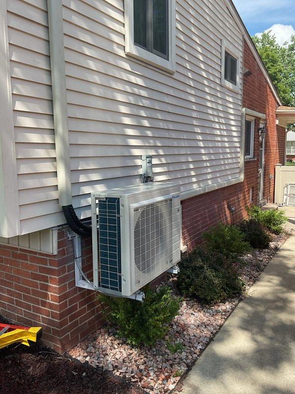 Completed full multi-zone mini split system installation over a five-day period, including two outdoor Daikin condensing units mounted on brick foundation with corresponding indoor air handlers. Ran refrigerant line sets with protective covers, installed new electrical circuit and conduit routing, and completed all mechanical and electrical connections per manufacturer specifications. System tested and operational with all components properly secured, landscaping restored, and installation site cleared of debris.