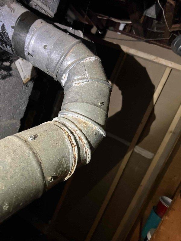 Completed comprehensive tune-up and inspection on 10-year-old furnace system located in basement. During inspection, identified significant crack in supply plenum ductwork that requires immediate attention to prevent air loss and efficiency degradation. Documented aged and deteriorated insulation on main trunk line ductwork in attic space showing visible dirt accumulation and wear at connection points. Performed standard maintenance procedures including filter inspection, burner assembly cleaning, heat exchanger examination, blower motor lubrication, thermostat calibration, and combustion analysis to ensure safe and efficient operation. System is currently operational but recommend scheduling ductwork repairs to address the cracked plenum and consider re-insulating trunk line to restore proper thermal efficiency and airflow distribution throughout the home.