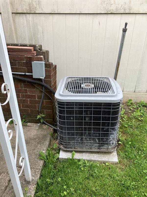 Conducted comprehensive inspection of 10-year-old furnace system located in basement following reports of operational concerns. Upon examination, identified cracked heat exchanger requiring immediate shutdown for safety reasons. Evaluated existing R22 refrigerant air conditioning system and outdoor condensing unit positioned on concrete pad in backyard area. Provided full system estimate for complete HVAC replacement due to failed heat exchanger and obsolete R22 refrigerant technology, documenting equipment condition through photographic records of outdoor condensing unit installation, electrical connections, and refrigerant line routing.