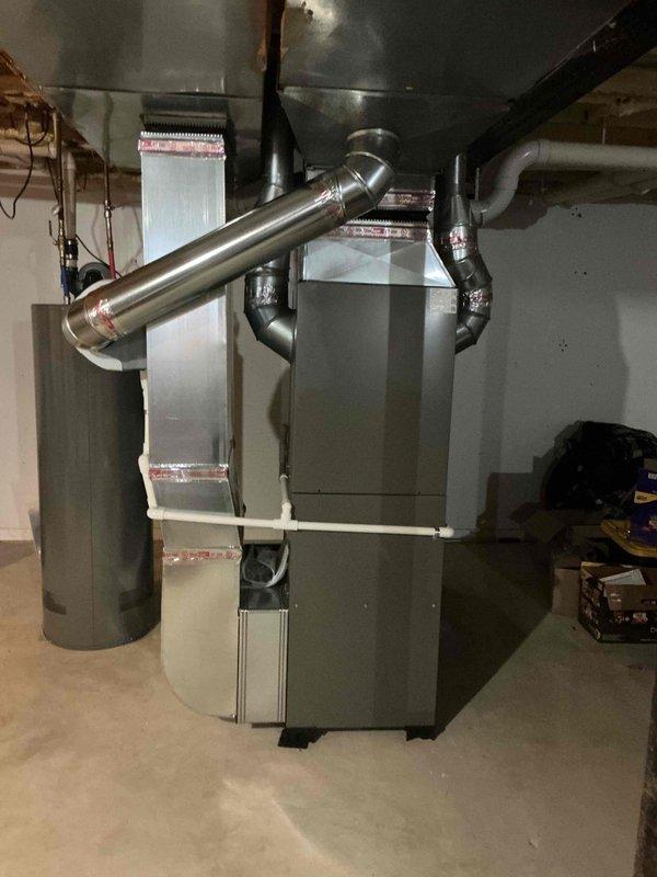 Completed full HVAC system installation including 110,000 BTU furnace and 3.5-ton air conditioning unit in basement mechanical room. Installed new thermostat, humidifier, and configured all ductwork connections with proper supply and return air pathways. Established PVC condensate drainage system, reconnected electrical service, and completed all mechanical and electrical permit requirements per specifications.