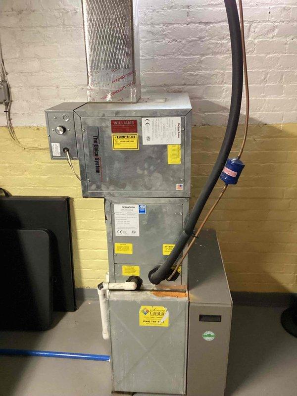 Completed comprehensive Gold AC inspection on two HVAC systems serving residential property, including a 7-year-old unit and a 1-year-old unit with equipment located in attic and basement areas. Performed thorough evaluation of basement-mounted air handler system, inspecting stacked components, control panels, ductwork connections, refrigerant lines, and electrical connections at breaker panel. Documented current condition of both systems including filter assemblies, Energy Star rated components, flexible duct routing, and copper line sets with proper insulation. Provided detailed replacement estimate for aging 7-year-old system based on inspection findings and equipment performance assessment.