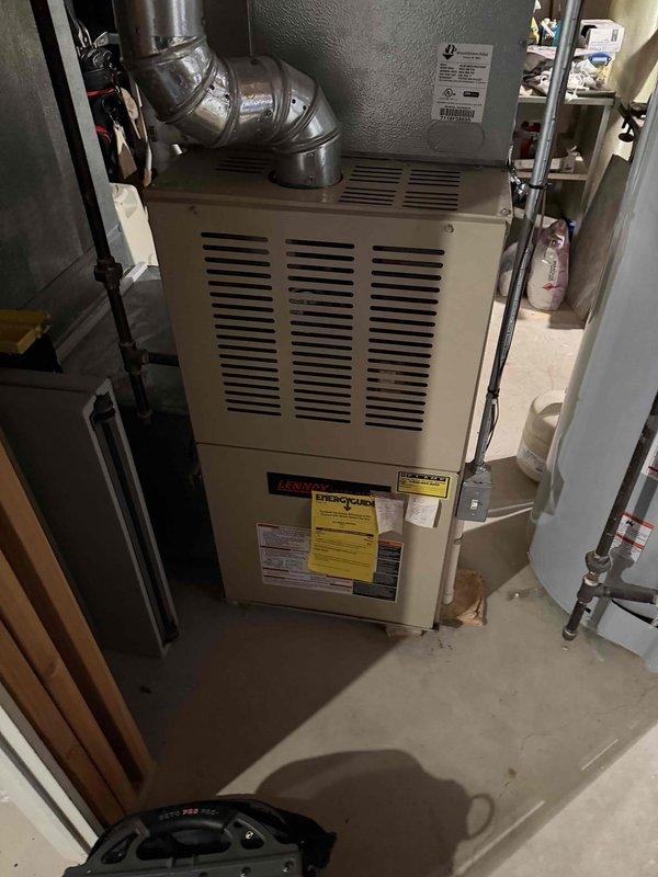 Completed comprehensive Gold AC Inspection on 6-year-old residential HVAC system with basement-located air handler. Performed multi-point inspection of Lennox furnace unit, examined outdoor condensing unit including refrigerant line connections and service valves, verified proper operation of all system components, and documented equipment condition with photographic records. All components found to be functioning properly with normal wear consistent with equipment age.