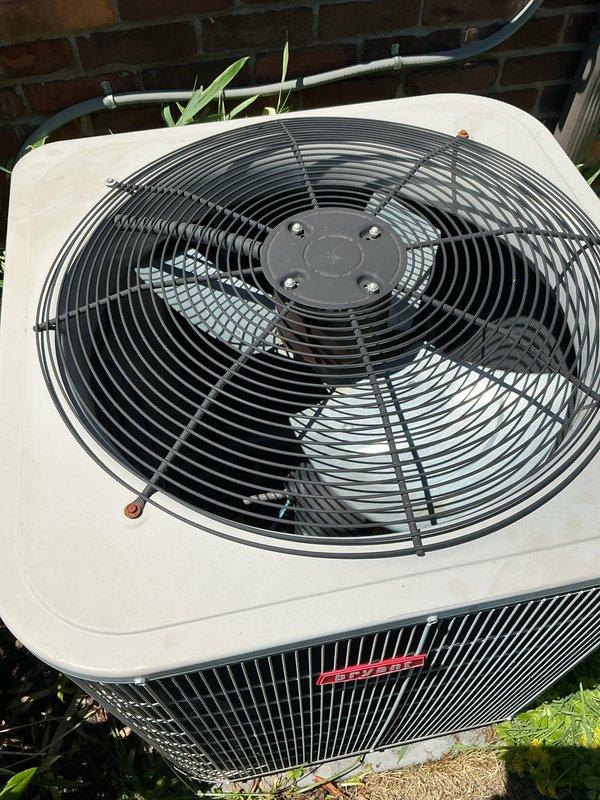 Completed comprehensive Gold AC Inspection on 10+ year old Bryant outdoor condensing unit located adjacent to home exterior. Performed thorough visual assessment of equipment condition, verified operational status of system components including fan assembly, motor, and cabinet integrity. Inspected condenser coil protection, mounting stability, and surrounding clearance from landscaping. Documented equipment condition through detailed photography showing unit positioning, fan guard assembly, manufacturer identification, and proper installation against brick foundation. Air handler/coil system located in basement confirmed as part of single-zone residential HVAC system. All major components found intact with unit in working condition at time of inspection.