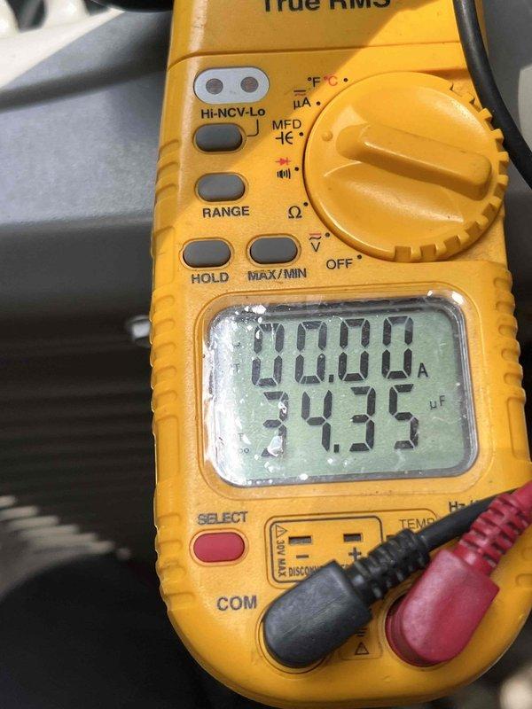 Responded to no cooling call on 10+ year old air conditioning system located in basement. Upon arrival, performed diagnostic testing of electrical components using digital multimeter to measure capacitance and verify proper voltage supply to unit. Customer reported suspicion of damaged wiring from possible rodent activity. Inspected system wiring and electrical connections, tested capacitor readings which displayed 34.95 microfarads on meter, and verified thermostat operation and communication with outdoor condensing unit. Documented equipment condition and test results for homeowner's records.