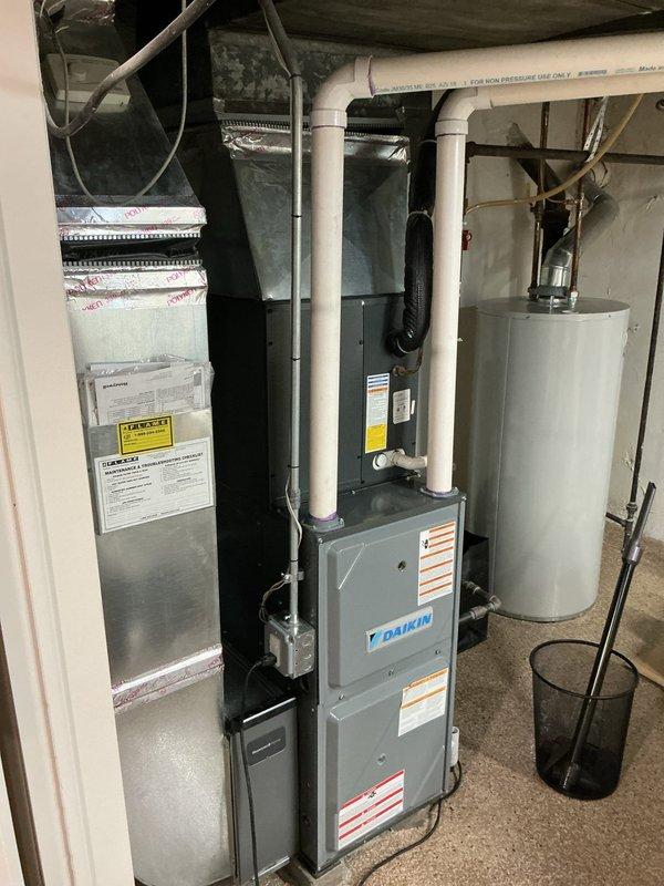 Completed comprehensive AC tune-up and system maintenance on residential HVAC equipment including 5-year-old Daikin furnace located in basement, air conditioning system, and water heater. Repositioned and leveled outdoor condenser unit back onto concrete pad to ensure proper operation and drainage. Performed routine preventative maintenance inspections on all systems, verified Nest thermostat operation and temperature settings, checked all connections and components with no issues identified.