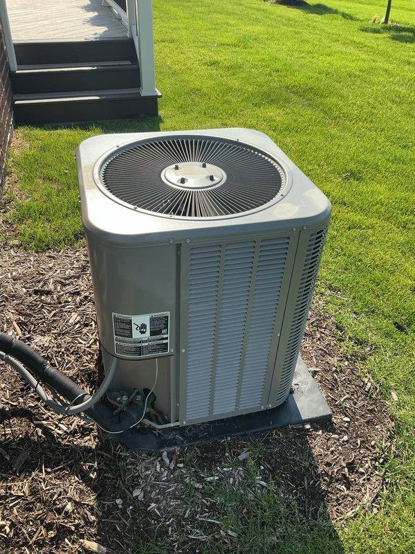 Completed Gold AC Inspection on a 4-year-old residential air conditioning system with air handler located in basement and condenser unit positioned on concrete pad in yard. Performed comprehensive multi-point inspection including visual assessment of outdoor condenser unit, verified proper equipment operation, checked refrigerant lines and electrical connections, and documented equipment condition with unit showing no visible signs of damage, rust, or deterioration.