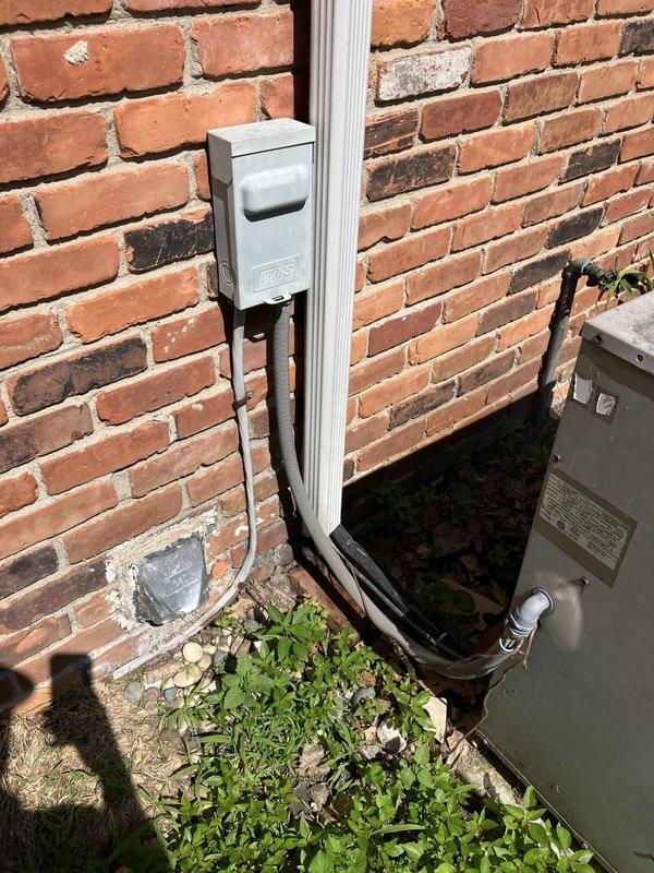 Completed HVAC system assessment for large residential cooling system replacement in attic-mounted configuration. Evaluated existing outdoor condensing unit mounted on exterior brick wall with weathered electrical disconnect and conduit installation. Inspected main electrical panel to verify circuit capacity and breaker configuration for heat pump and furnace connections. Provided estimate for Lennox vertical upflow/downflow A/C coil system suitable for 3000+ square foot application, including equipment specifications and installation requirements for attic unit location.