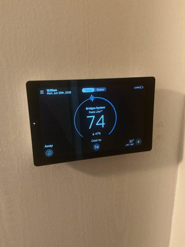 Completed comprehensive Gold AC Inspection on a five-year-old Lennox residential air conditioning system. Performed full system evaluation including refrigerant line inspection, condenser unit examination with horizontal louver assessment, and thermostat functionality verification showing proper cooling operation to setpoint of 74°F. Unit operating efficiently with no issues identified; system maintaining proper temperature differential between indoor setting and outdoor ambient temperature of 81°F.