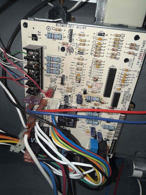 Responded to no heat call on 10-year-old furnace located in basement. Upon arrival, confirmed system was completely off with no heat to entire home. Performed diagnostic inspection of furnace control board and electrical connections. Examined blower control circuit board showing blower off delay module with multiple wire terminations and connections intact. Verified all wire harness connections at terminal blocks were secure with proper color-coded wiring to board. Inspected electrical cable bundle routing through equipment cabinet with appropriate insulation protection at penetration points. Diagnosed control board failure preventing system operation. Replaced faulty control board and restored all electrical connections to proper terminals. Cycled system through complete heating operation, verified ignition sequence, confirmed blower motor engaged on proper delay timing, and validated adequate heat output to distribution system. System restored to full operational status with no heat 