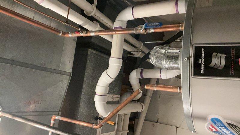 Completed comprehensive Gold AC inspection on multi-unit residential system consisting of two air conditioning units and one generator, all ranging from 3-10+ years in age. Performed thorough evaluation of basement-located mini split, air handler, and evaporator coil assemblies. Inspected mechanical room housing gray metal cabinet-style HVAC equipment, verifying proper clearances and accessibility for future maintenance. Examined all refrigerant line sets, copper piping connections, and soldered joints for signs of wear or potential leaks. Assessed white PVC condensate drainage system with multiple bends and connections, confirming proper pitch and flow. Verified blue valve operation on copper refrigerant lines and inspected flexible silver ventilation ductwork for proper sealing and support. Evaluated electrical connections, mounting hardware, and safety controls on all units. Checked metal rectangular duct system for proper sealing at seams and joints. Confirmed all equipment operati