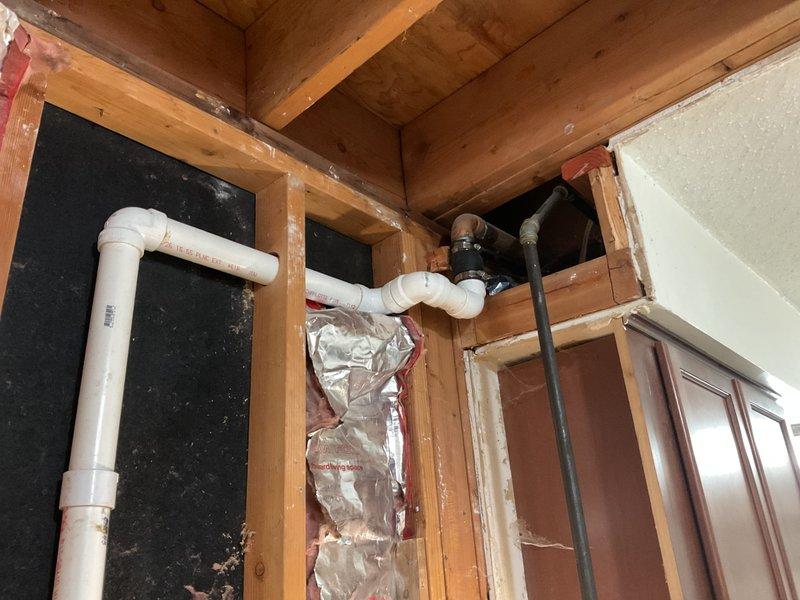 Conducted site assessment for gas line installation at residential property. Evaluated existing utility infrastructure including gas meter location at exterior brick wall and interior routing requirements through ceiling cavity above cabinetry. Inspected ceiling joists, existing plumbing lines, and available pathways for proposed gas line installation. Provided quote for gas line installation work including materials and labor required to connect from exterior meter to interior appliance location.
