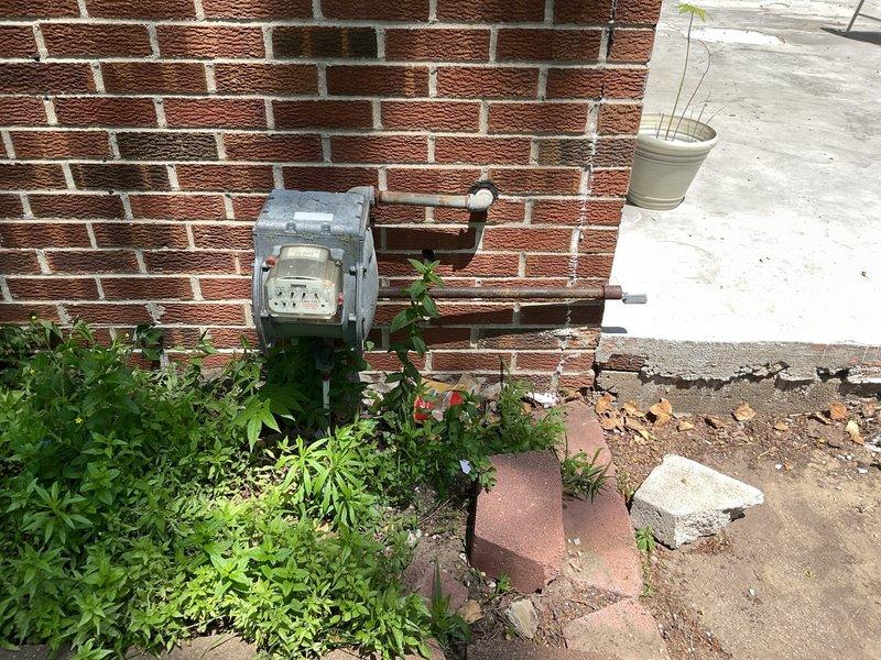 Conducted site assessment for gas line installation at residential property. Evaluated existing utility infrastructure including gas meter location at exterior brick wall and interior routing requirements through ceiling cavity above cabinetry. Inspected ceiling joists, existing plumbing lines, and available pathways for proposed gas line installation. Provided quote for gas line installation work including materials and labor required to connect from exterior meter to interior appliance location.